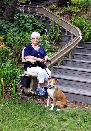 A lady with her dog using an outdoor Lift